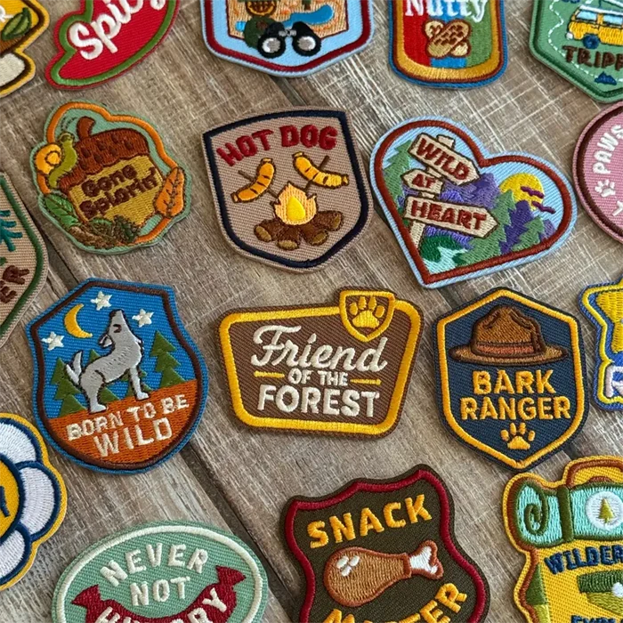 Collection of various embroidered patches on a wooden surface
